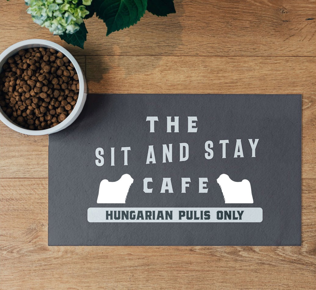'Sit and Stay Cafe' Feeding Mat - flatlay on wooden floor with bowl