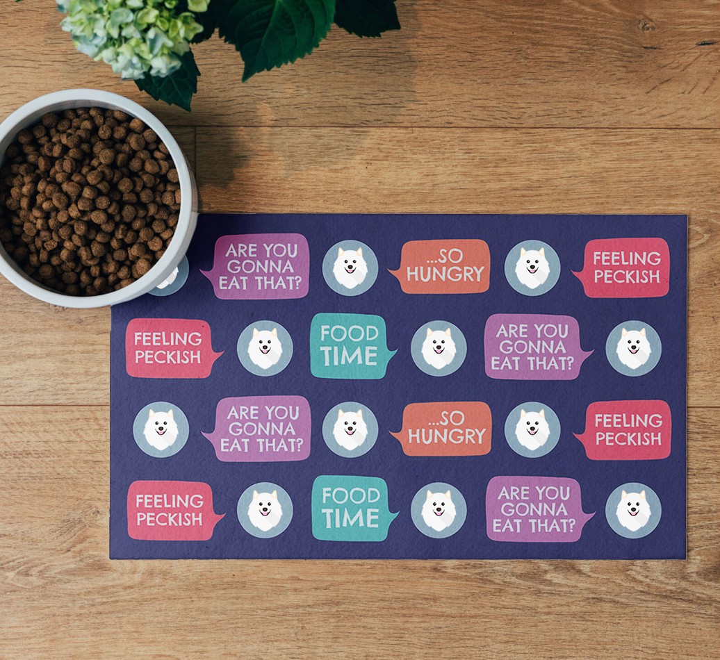 Speech Bubbles: Personalised {breedFullName} Feeding Mat- flatlay on wooden floor with bowl