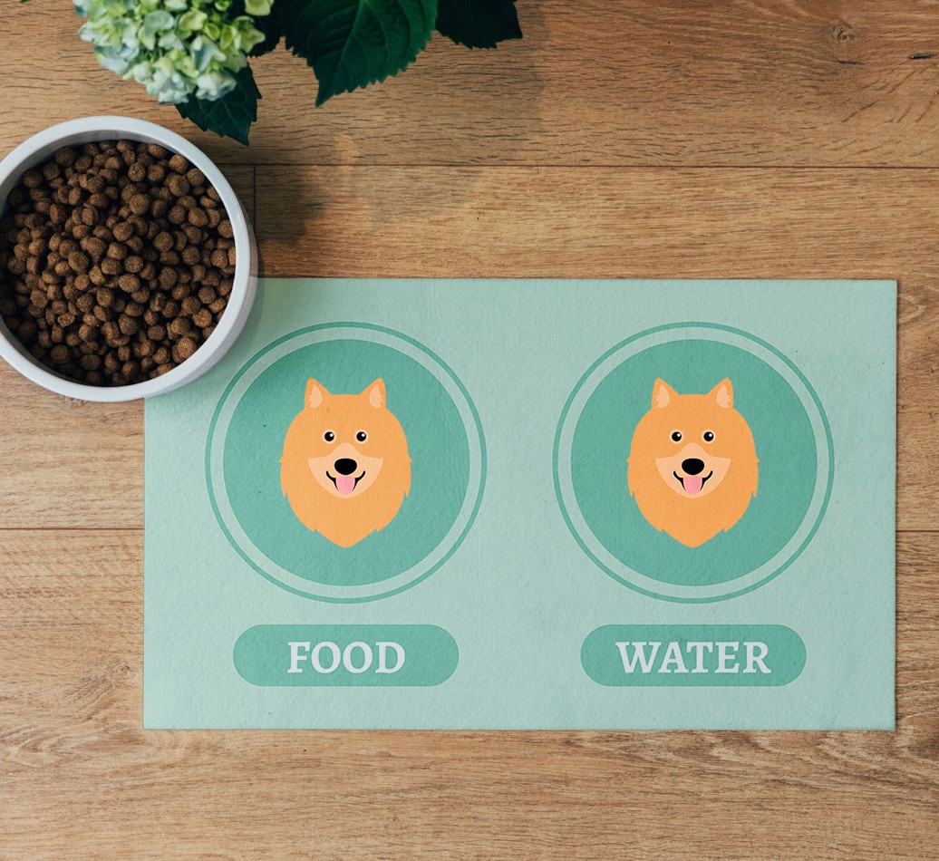 'Yappicons' Feeding Mat - flatlay on wooden floor with bowl