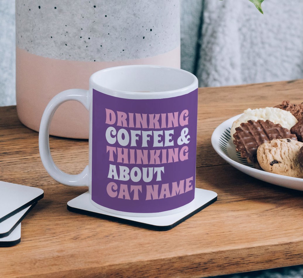 Drinking Coffee: Personalized {breedCommonName} Mug - on a coffee table