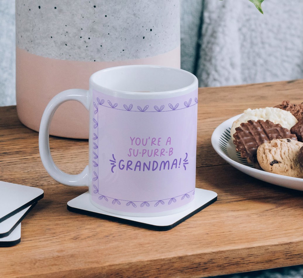 You're A Su-purr-b Grandma: Personalized {breedCommonName} Mug - on a coffee table