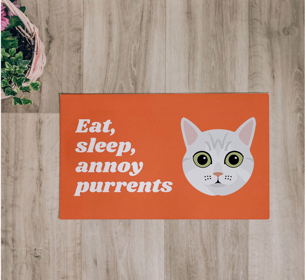 Eat, Sleep, Annoy Purrents: Personalised {breedCommonName} Feeding Mat - flatlay on wooden floor