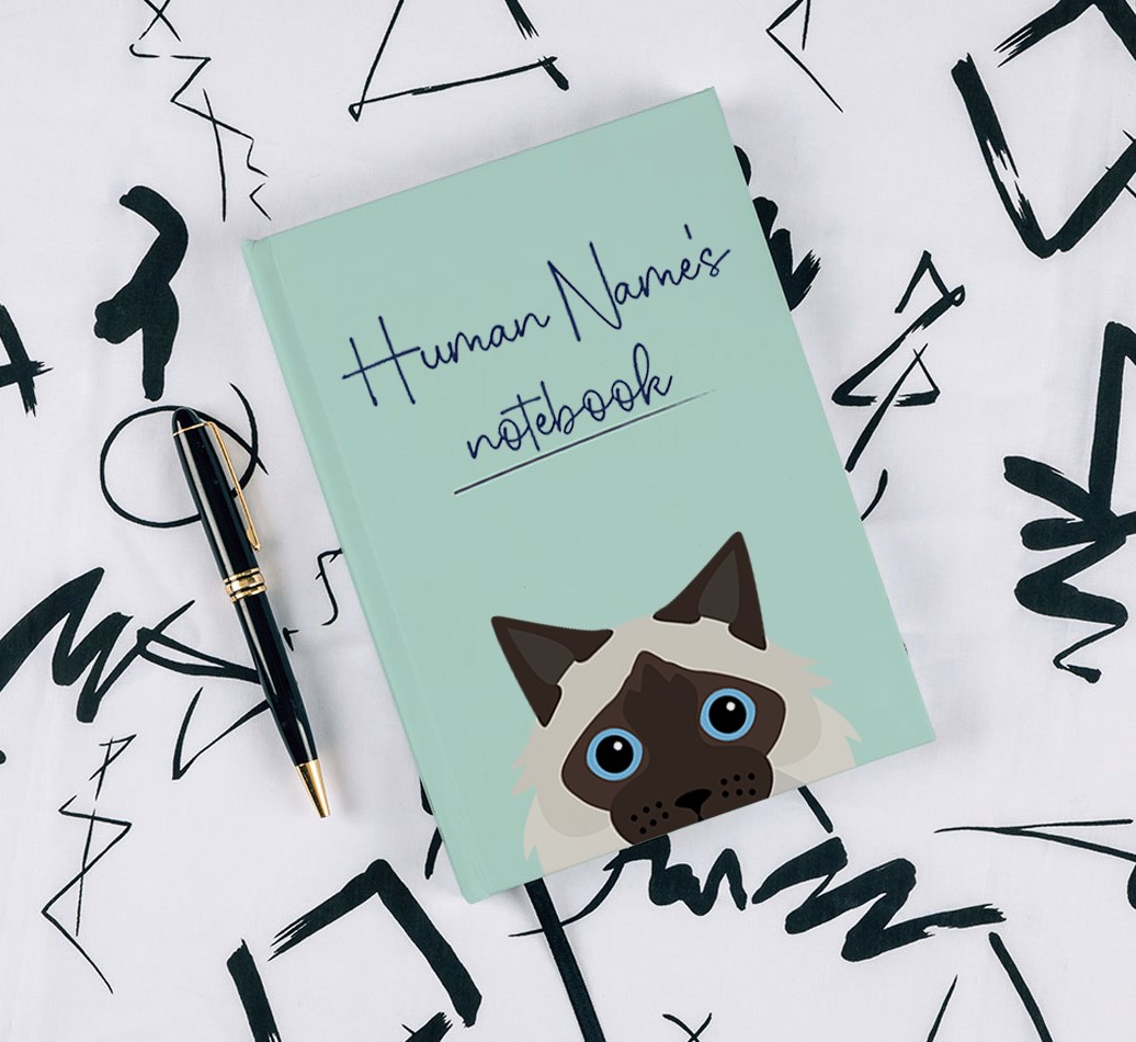Handwritten: Personalized {breedFullName} Notebook - with pen on black & white pattern background