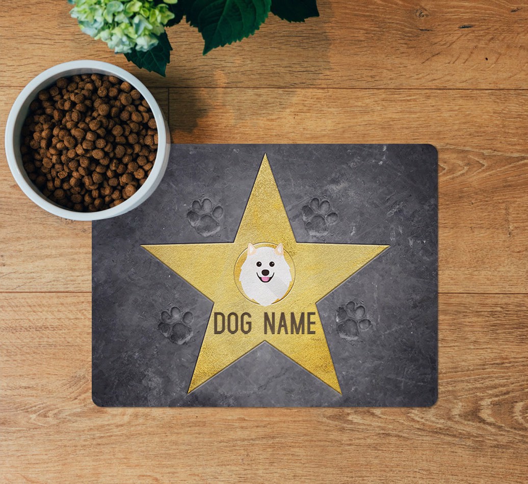 Star of Fame: Personalised {breedFullName} Feeding Mat - layed flat on wooden floor with bowl
