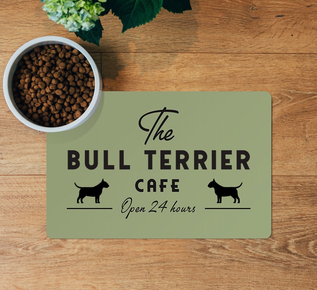 The {breedFullName} Cafe: Personalized Placemat - layed flat on wooden floor with bowl