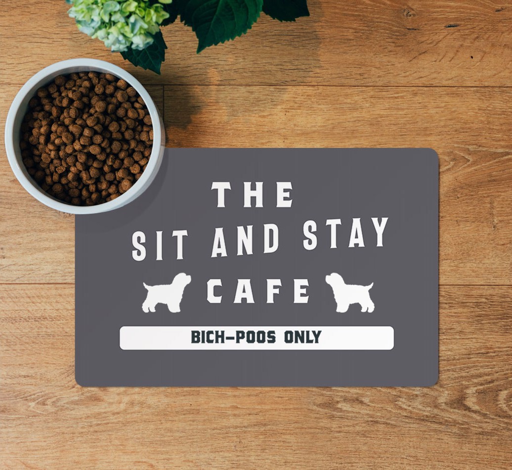 Sit and Stay Cafe: Personalized {breedFullName} Feeding Mat - layed flat on wooden floor with bowl