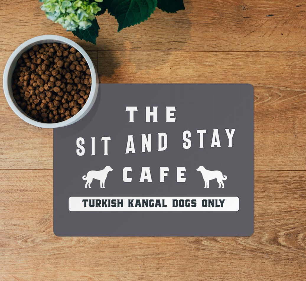 Sit and Stay Cafe: Personalised {breedFullName} Feeding Mat - layed flat on wooden floor with bowl