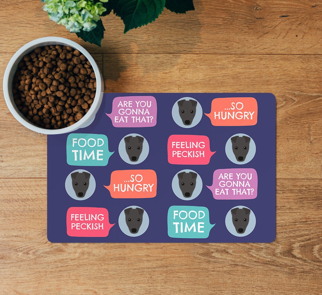 Speech Bubbles: Personalized {breedFullName} Feeding Mat - layed flat on wooden floor with bowl