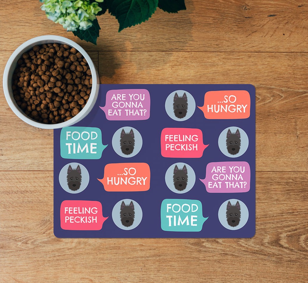 Speech Bubbles: Personalised {breedFullName} Feeding Mat - layed flat on wooden floor with bowl