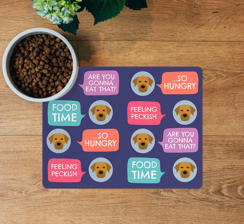 Speech Bubbles: Personalised {breedFullName} Feeding Mat - layed flat on wooden floor with bowl