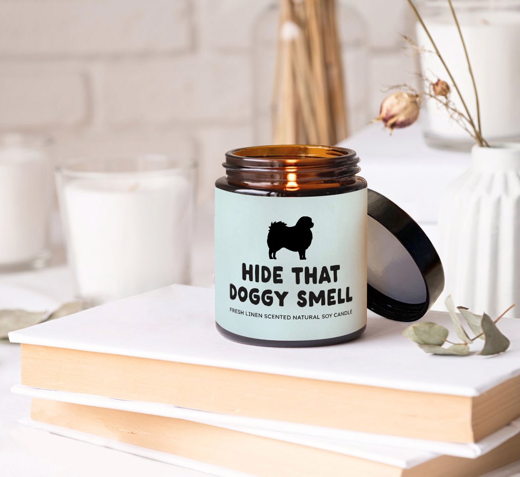 Hide That Doggy Smell: Personalised Candle - on books on a bedside table
