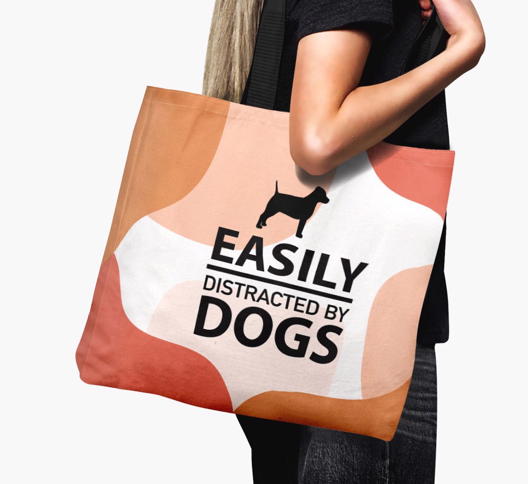 Woman holding 'Easily Distracted by Dogs' - Personalized {breedFullName} Canvas Bag