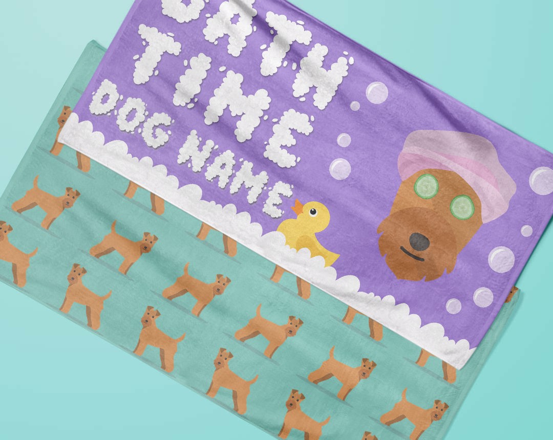 Two towels laying flat with personalised dog designs